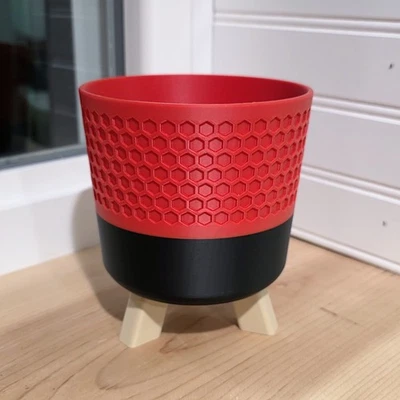 Maceta de panal impresa en 3D con pies en rojo Foto 1 de 3