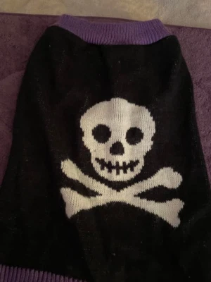 MARTHA STEWART PETS MEDIUM DOG SWEATER BLACK AND PURPLE WITH SKULLS GENTLY USED  - Image 1 of 2