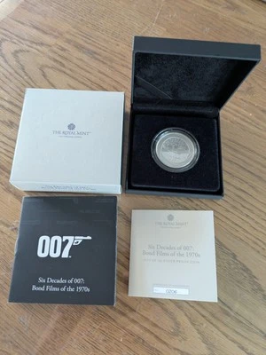 Moneda de plata 2024 seis décadas de 007 James Bond años 70 1 OZ prueba con caja y certificado de autenticidad Foto 1 de 4
