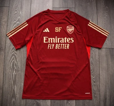 CAMISETA DE FUTBOL DE ENTRENAMIENTO ARSENAL LONDRES 2023/2024 ROJA Y DORADA TALLA HOMBRE L ADULTO Foto 1 de 4