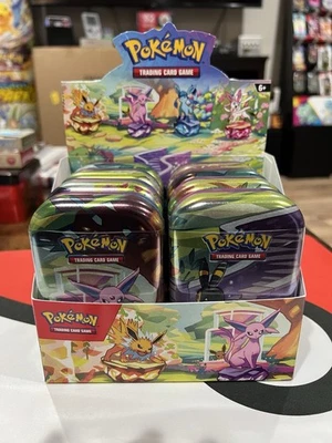 Prismatic Evolutions - Set of 8 Sealed Mini Tins w/ Open Display Box - Image 1 of 4