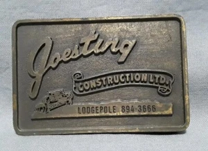 Hebilla de cinturón de metal publicidad vintage Joesting Construction LTD Lodgepole 894-3666 - Imagen 1 de 5