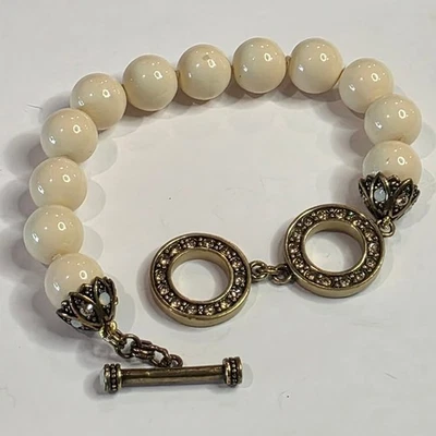 Pulsera Heidi Daus Cristal Palanca Crema Perla Tono Dorado Dije Foto 1 de 4