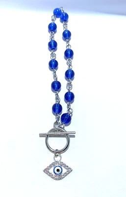 Pulsera con dije de mal de ojo azul cristal Foto 1 de 2