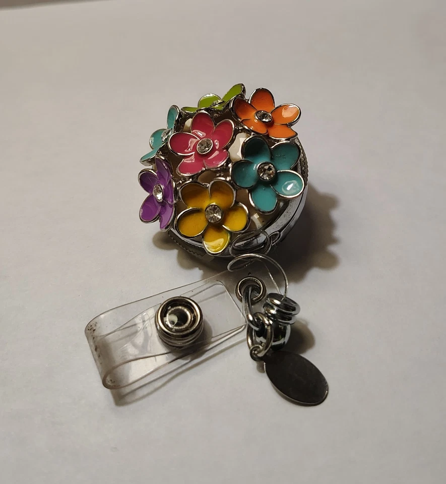 Soporte de insignia retráctil de flores coloridas - Etiqueta de cordón de carrete de metal de alta resistencia Foto 1 de 4