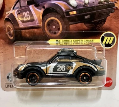 Matchbox 1985 Porsche 911 Rally Super Chase 1/64 (2026 estuche A) con protector Foto 1 de 4