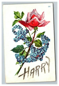 Cartolina d'epoca '900 con nome in rilievo rosa rosa e fiori blu-Harry in glitter - Foto 1 di 2