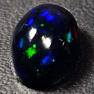 NATURAL AAA+ AMAZING COLOR PLAY OVAL CABOCHAN  ETHIOPIAN WELO BLACK OPAL 1.80CTS - Image 1 of 3