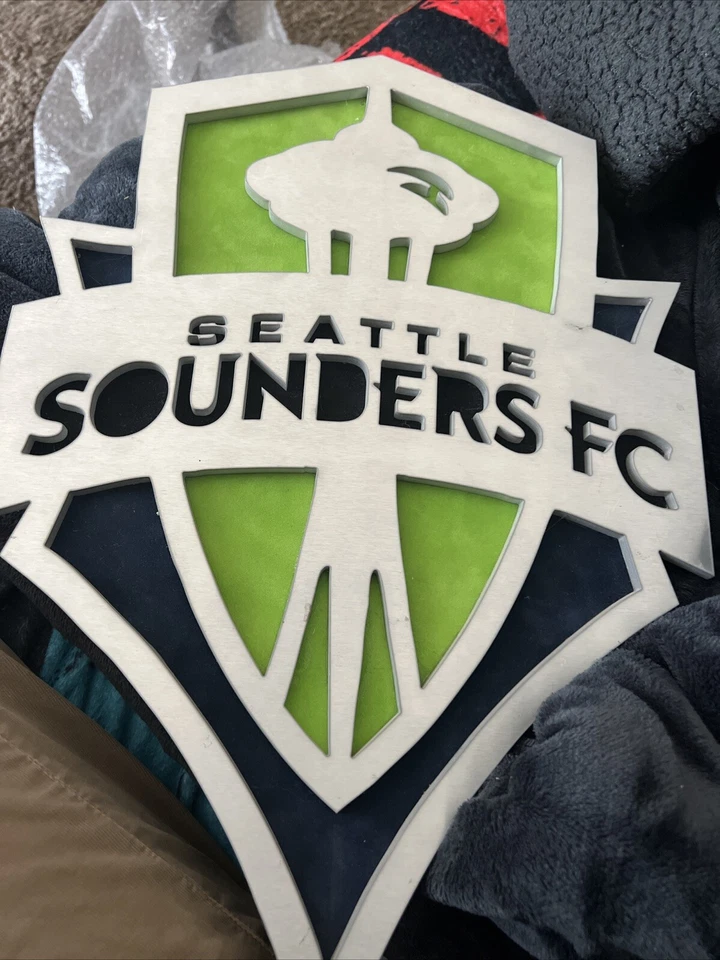 MLS Seattle Sounders FC Metal/Felt Logo 17”x12” Hanging Wall Sign - Image 1 of 2