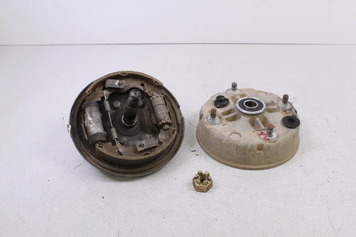 1986 KAWASAKI BAYOU 300 KLF 300 Front Left Brake Plate Panel with Hub - Image 1 of 1