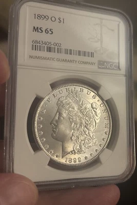 1899 O Morgan Dollar Silver Dollar, NGC MS65, perfectly smooth cheek, beautiful  - Image 1 of 4