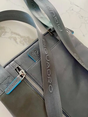 PIQUADRO authentic soft grey bright blue men's crossbody bag; good condition - Image 1 of 4