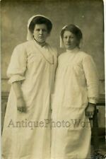 Two nurses posing in uniforms antique photo