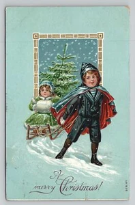 Postal de Navidad niño tirando niña en trineo con árbol Philadelphia PA Cancelar - Imagen 1 de 2