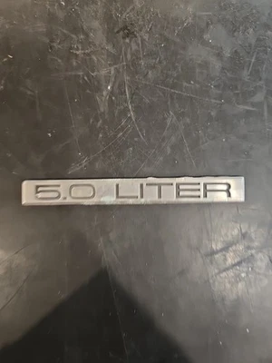 1986 1987 1988 1989 Cadillac Brougham d'elegance - 5.0 Liter Trunk Emblem - Image 1 of 3