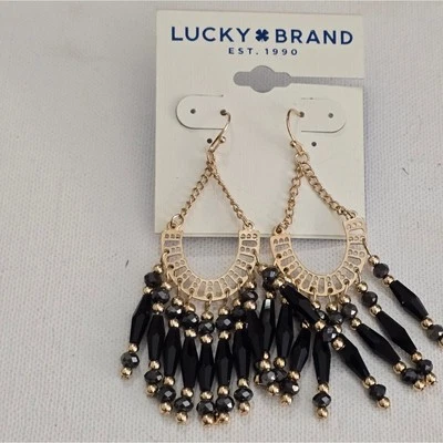 Pendientes colgantes con borla negra y dorada marca Lucky Foto 1 de 2