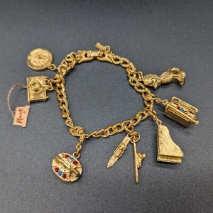 MONET GOLD TONE 7 CHARM BRACELET CAMERA, PIANO, PHONE, SKIS, TYPEWRITER, ETC... - Picture 1 of 8