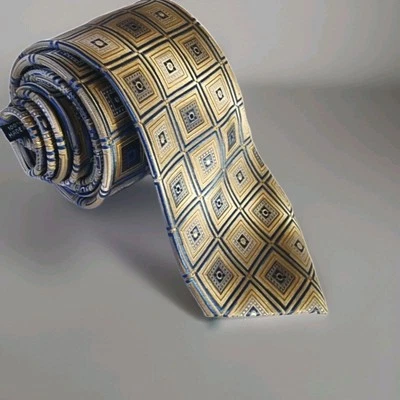 Corbata Pronto Uomo Couture 100 % seda azul con patrón geométrico dorado y plateado.   Foto 1 de 4