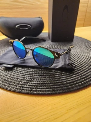 Lente polarizada Oakley Deadbolt marco de metal titanio azul Prizm totalmente nueva Foto 1 de 4