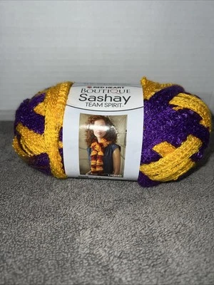 Red Heart Boutique Sashay Team Spirt Ribbon Yarn 1933 Purple/Gold 3.5oz 30 Yards - Image 1 of 2