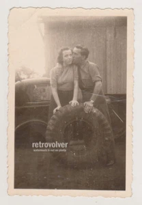 Young Man Kisses His Girl Lovers with Tire Waiting to Be Changed Snapshot Photo - Picture 1 of 7