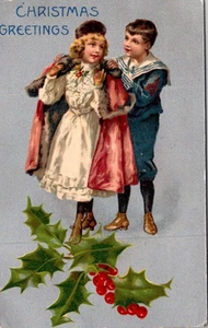 Postcard Christmas Greetings Boy Helping Girl Into Her Coat Silver Foil - Picture 1 of 2
