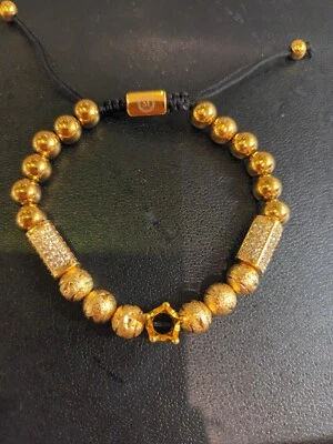 Браслет золотистого цвета с подвесками в виде шаровой короны и регулируемыми струнами - Изображение 1 из 4