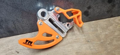 T.M. Kit protector de disco trasero y pinza Designworks naranja para KTM HUSQVARNA GASGAS Foto 1 de 3