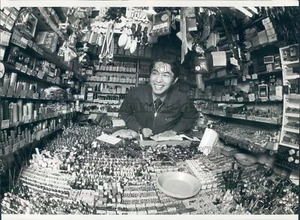 Press Photo Smiling Electronics Dealer in Cramped Booth Akihabara Tokyo - Picture 1 of 2