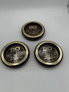 Vintage Set Of 3 UPS 80 Year 1907 1987 Brown Gold Plastic Drink Coasters USA - Picture 1 of 7