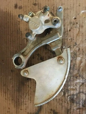 2007 KAWASAKI KX450F REAR BRAKE CALIPER ASSEMBLY WITH METAL DISC GUARD - Image 1 of 4