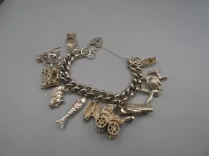 VINTAGE SOLID SILVER CHARM BRACELET - 114 GRAMS - 11 CHARMS - SOME RARE - Picture 1 of 7