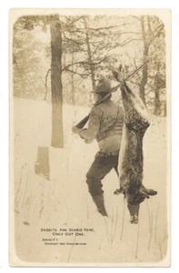1909 RPPC EXAGGERATION. HUNTER Hangs GIANT RABBIT from RIFLE Photo Art Shop C-1  - Picture 1 of 2