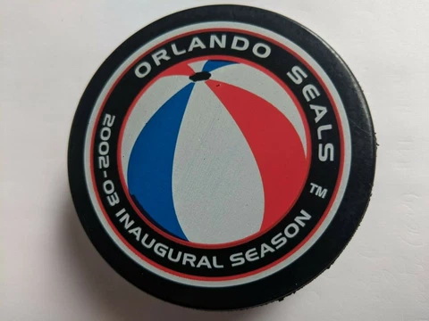 Orlando Seals ACHL puck - 2002-03 Inaugural Season - beach ball logo- In Glas Co Cover