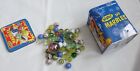 Toysmith Marbles in a Tin Box, has dents in box and 46 color marbles