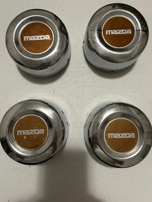 Комплект из 4 оригинальных центральных колпаков ступицы колеса Mazda B2000-B2200-B2600 - Изображение 1 из 4