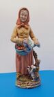 Stara kobieta zbierająca owoce z figurką psa. Made in Japan. Wysoki opat 15"