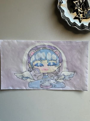 Ángel celestial con orejas de oso sosteniendo garabato de café en sobre de 3x6 Foto 1 de 4