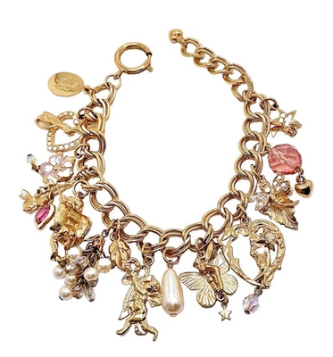 Brazalete vintage Kirks Folly tono dorado con dije - cara de luna, querubines y corazones raro Foto 1 de 4