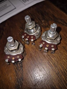 (3)  1965  500k guitar pots..long shaft...gibson/fender - Picture 1 of 10