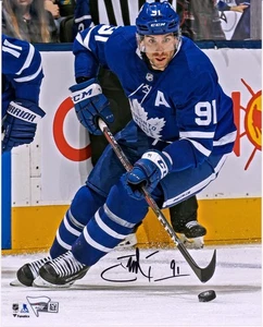 John Tavares Toronto Maple Leafs Signed 8 x 10 Blue Jersey Skating & Puck Photo - Picture 1 of 1