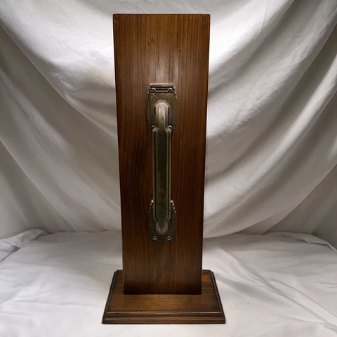 Vintage Door Pull With Lock and deadbolt mounted on a salesman sample Cover