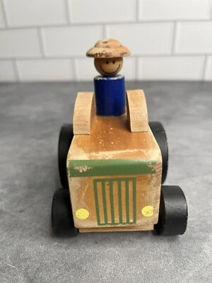 Vintage Green Wooden Tractor With Driver Wearing Blue Shirt and Hat - Image 1 of 4