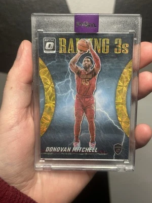 2023-24 Panini Donruss Optic Raining 3S Donovan Mitchell #8 Gold Prizm/10 Foto 1 de 4