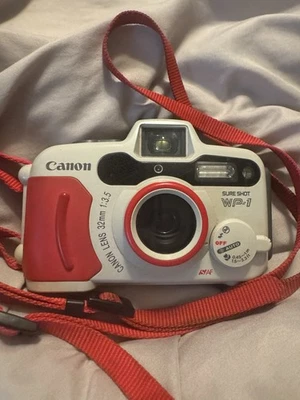 Câmera Canon Sure Shot WP-1 TESTADA à prova de intempéries/à prova d'água 35mm lente 32mm f/3.5 - Imagem 1 de 3