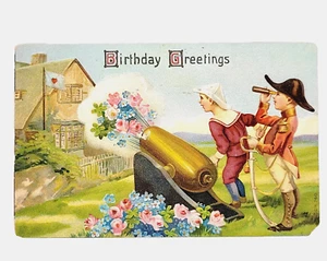 Carte postale canon années 1910 voeux d'anniversaire militaire enfants tirent fleurs - Photo 1/4