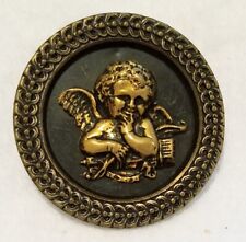 ANTIQUE TINTED BRASS BUTTON WITH A SMILING CUPID, LINK BORDER DESIGN, 1-11/16"