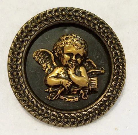 ANTIQUE TINTED BRASS BUTTON WITH A SMILING CUPID, LINK BORDER DESIGN, 1-11/16" Cover