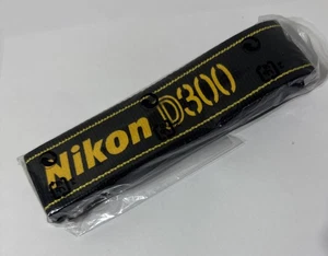 Cámara Nikon AN-DC300 correa para el cuello de hombro genuina OEM negra amarilla - Imagen 1 de 3