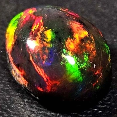 NATURAL AAA+ BEAUTIFUL COLORPLAY OVAL CABOCHAN  ETHIOPIAN WELO BLACK OPAL 1.60CT - Image 1 of 3